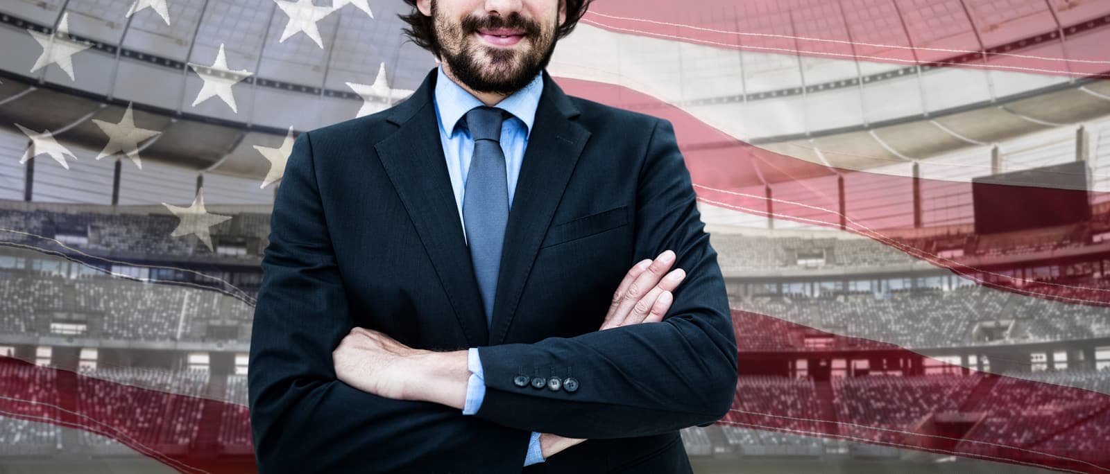 Investor standing in front of a U.S. flag inside a large venue